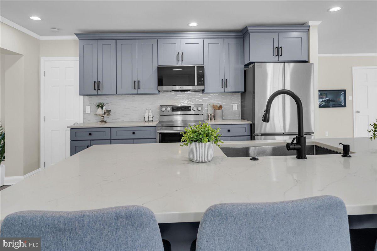 12 West Dale Road Wilmington, DE 19810 - Photo 15 of 44 a kitchen with stainless steel appliances a stove a sink a refrigerator and cabinets