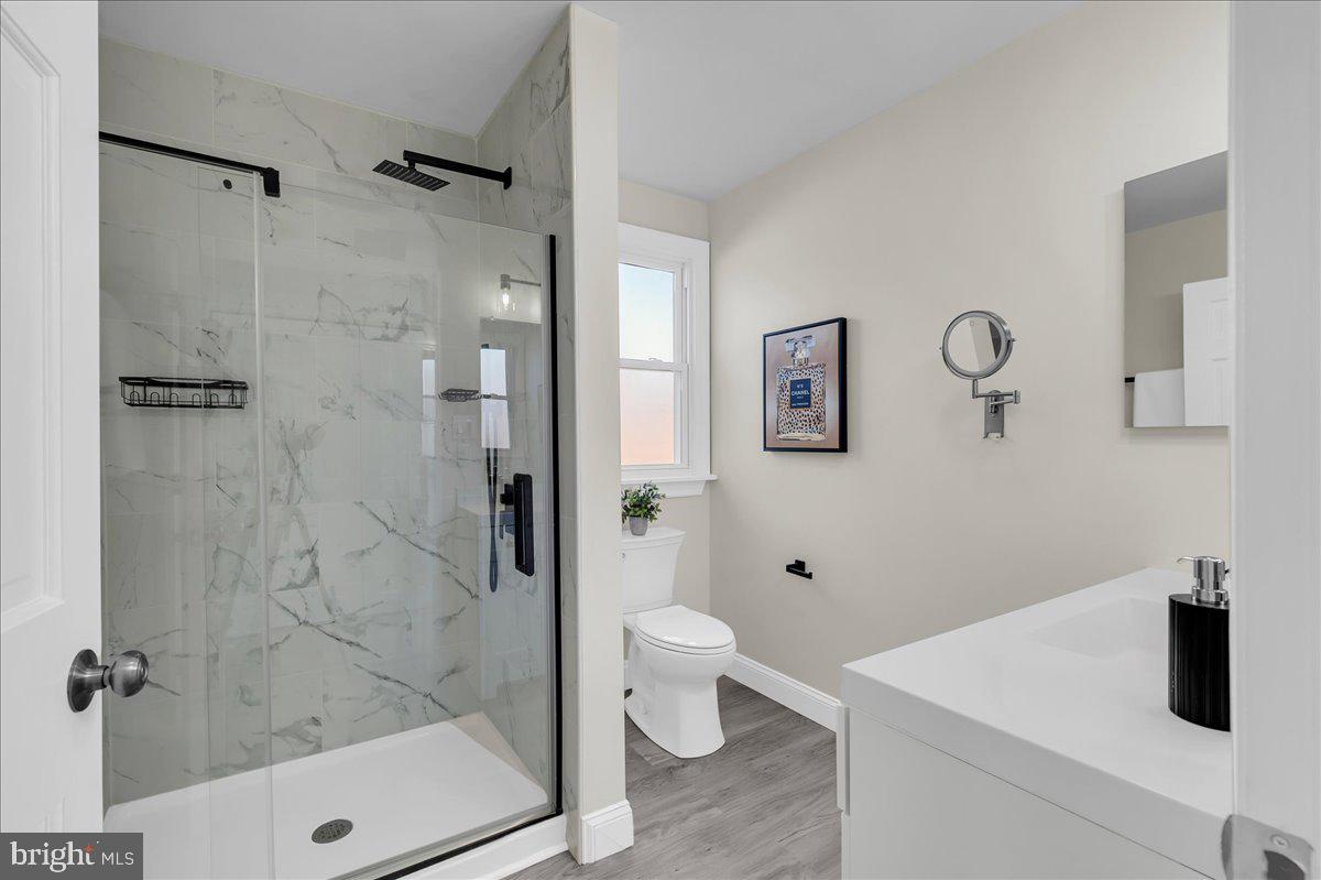 12 West Dale Road Wilmington, DE 19810 - Photo 22 of 44 a bathroom with a shower a toilet a sink and mirror