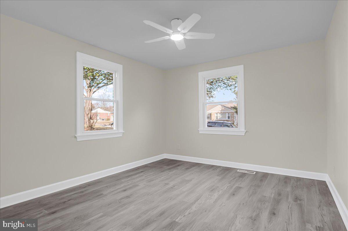 12 West Dale Road Wilmington, DE 19810 - Photo 24 of 44 a view of an empty room with wooden floor and a window