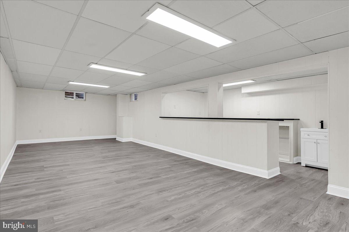 12 West Dale Road Wilmington, DE 19810 - Photo 32 of 44 a view of a big room with wooden floor and a refrigerator