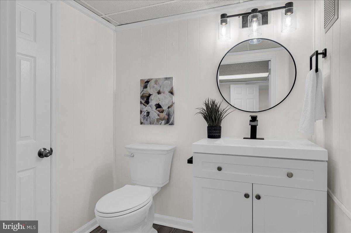 12 West Dale Road Wilmington, DE 19810 - Photo 34 of 44 a bathroom with a toilet sink vanity and mirror