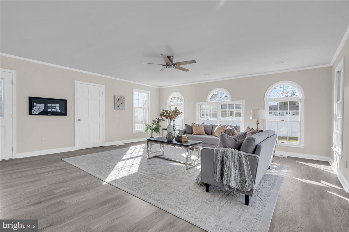12 West Dale Road Wilmington, DE 19810 - Photo 7 of 44 a living room with furniture a large window and a chandelier