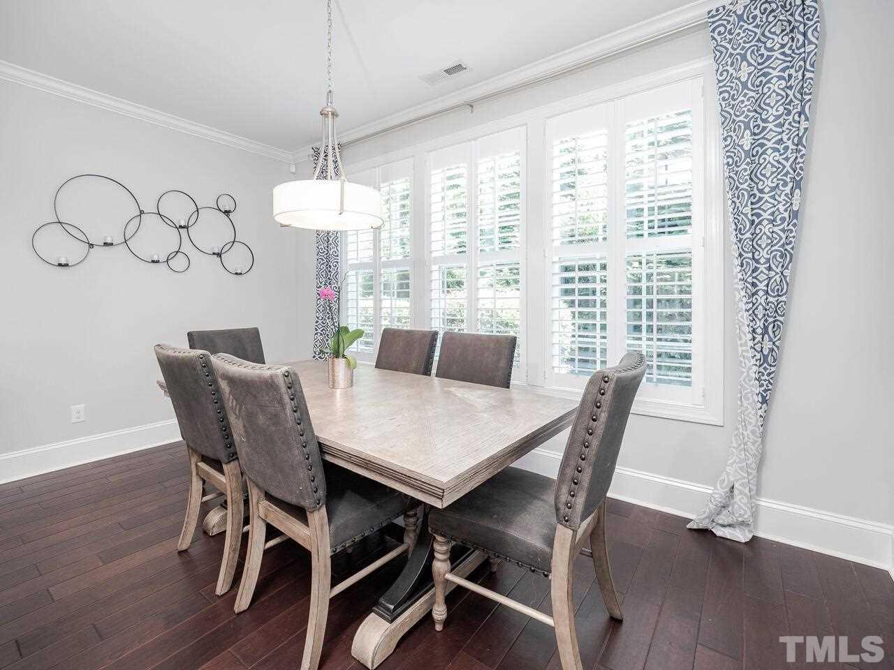 3936 Ivory Rose Lane Raleigh, NC 27612 - Photo 5 of 12 a view of a dining room with furniture window and wooden floor