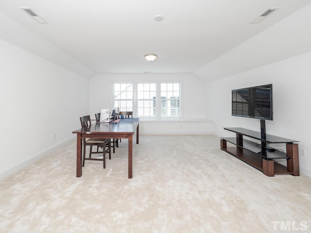 3936 Ivory Rose Lane Raleigh, NC 27612 - Photo 7 of 12 a workspace with furniture and window