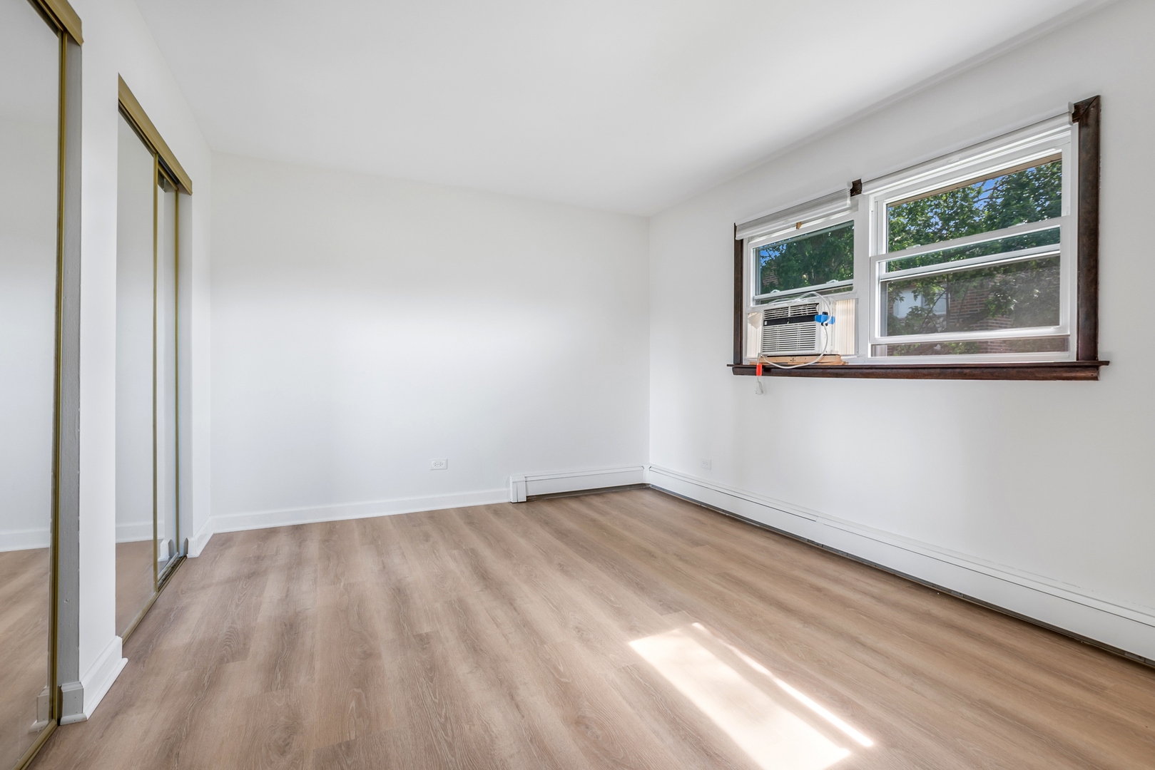 15290 El Cameno Terrace, Unit 2W Orland Park, IL 60462 - Photo 12 of 14 a view of empty room with wooden floor and fan