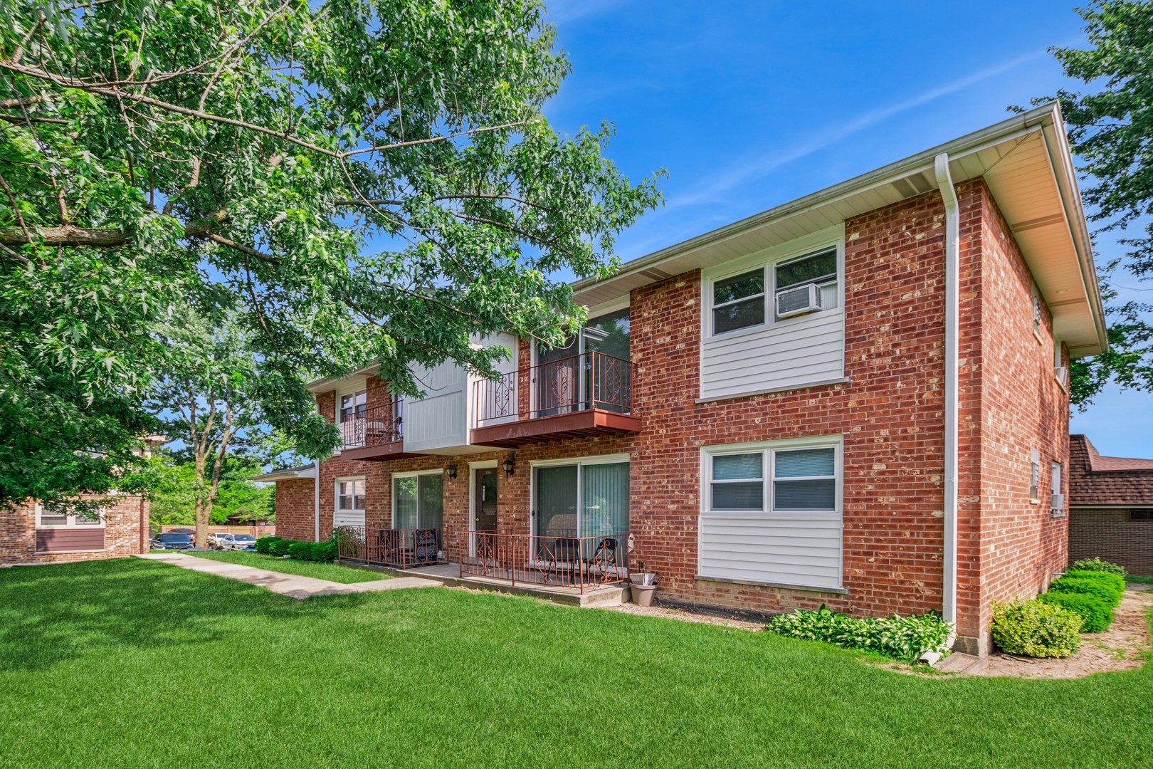 15290 El Cameno Terrace, Unit 2W Orland Park, IL 60462 - Photo 2 of 14 a view of a house with a yard porch and sitting area