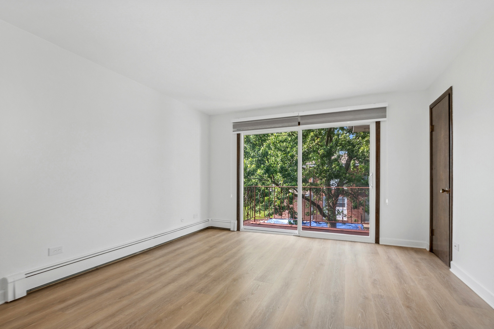 15290 El Cameno Terrace, Unit 2W Orland Park, IL 60462 - Photo 6 of 14 an empty room with wooden floor and windows