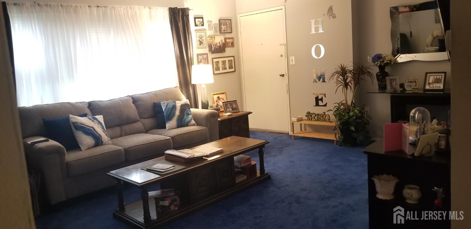 160 Evergreen Road, Unit 6A Edison, NJ 08837 - Photo 2 of 10 a living room with furniture and a window