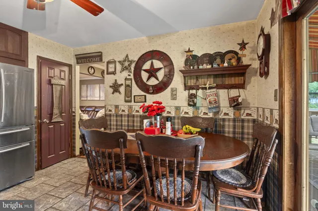 a dining room with furniture and window