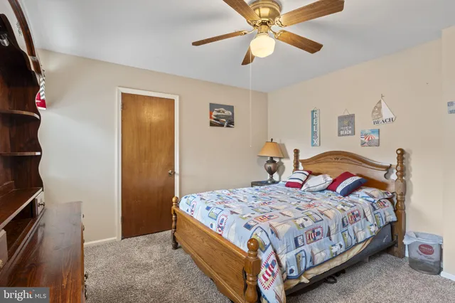 a bedroom with a bed and a ceiling fan