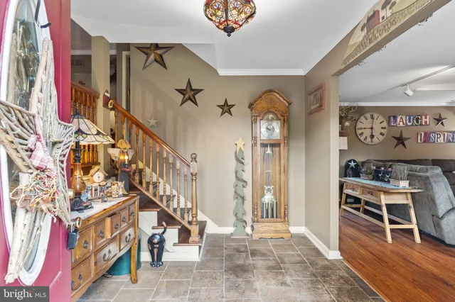 a view of entryway and hall with wooden floor