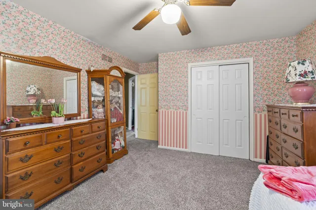 a bed room with a bed and a dresser