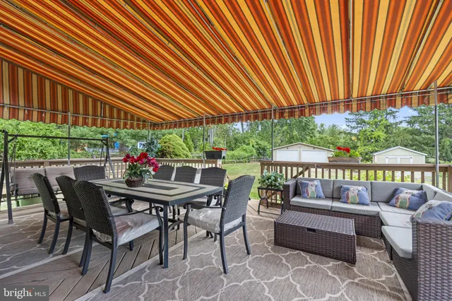 a patio with glass top table and chairs