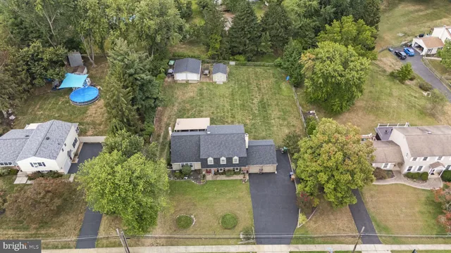an aerial view of house with yard swimming pool and outdoor seating