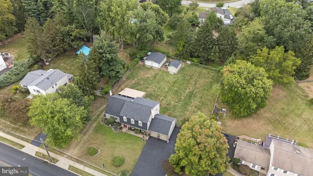 aerial view of a house with a yard and large tree