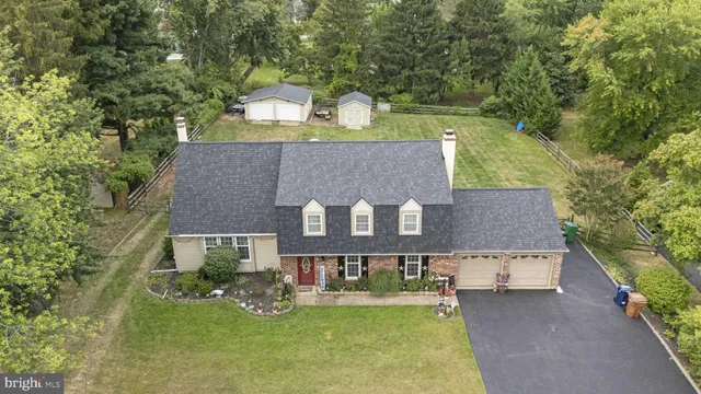 a view of a house with a yard and garage