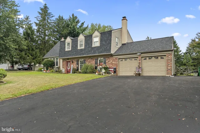 a front view of a house with a garden and plants