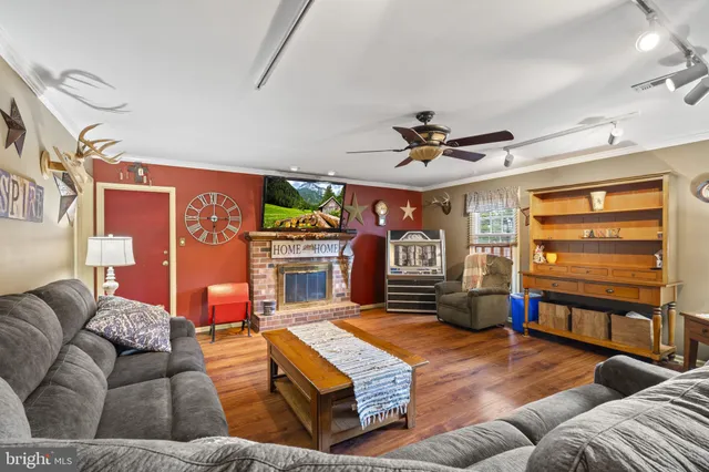 a living room with fireplace furniture and a flat screen tv