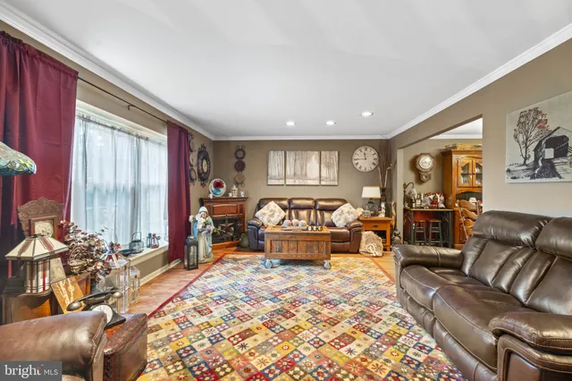 a living room with furniture and large windows