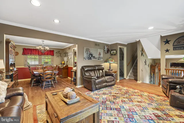 a living room with fireplace furniture and a rug
