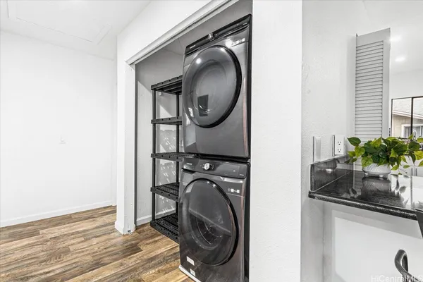 an empty room with wooden floor and window