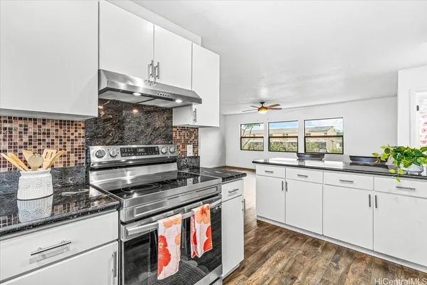a kitchen with stainless steel appliances granite countertop a stove and a sink