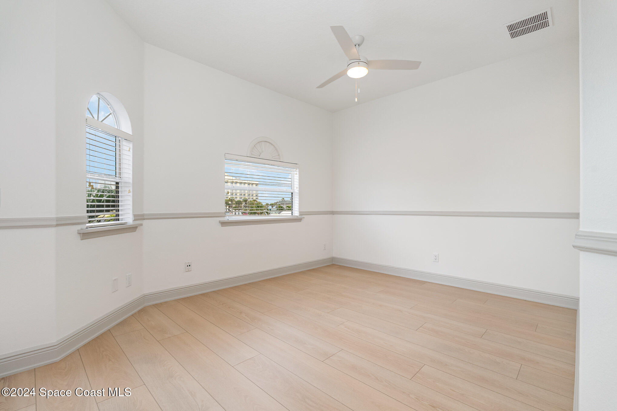 16 South Court Indialantic, FL 32903 - Photo 16 of 20 an empty room with windows and fan