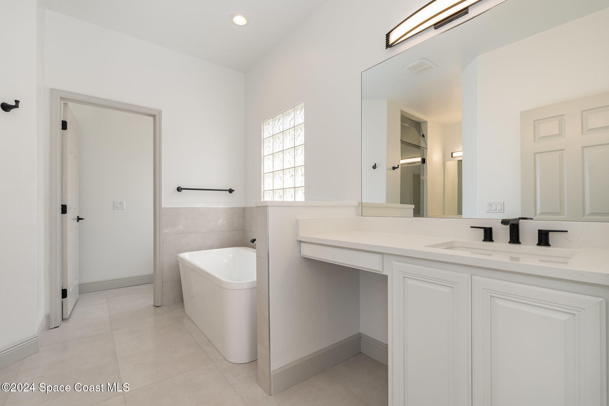 16 South Court Indialantic, FL 32903 - Photo 20 of 20 a spacious bathroom with a granite countertop sink and a mirror