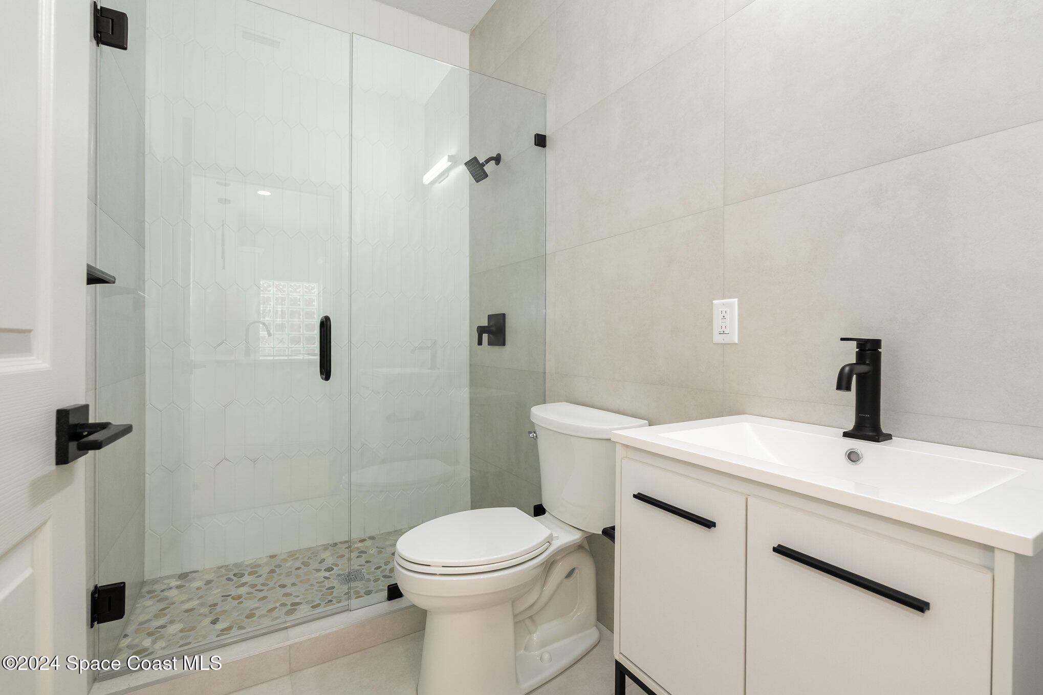 16 South Court Indialantic, FL 32903 - Photo 3 of 20 a bathroom with a sink a toilet and shower