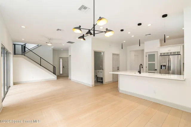 a view of a kitchen with furniture and a ceiling fan
