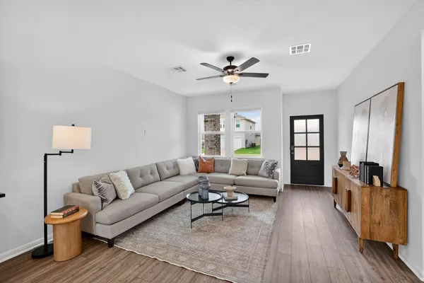 a living room with furniture and wooden floor