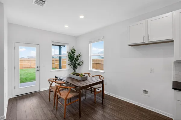 a view of a dining room with furniture and window