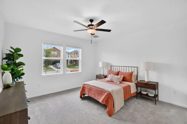 a bedroom with bed and a window