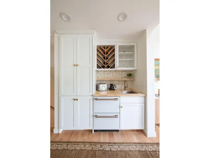 a living room with a couch and a cabinets