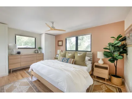 a bedroom with a bed potted plant with the view of mirror
