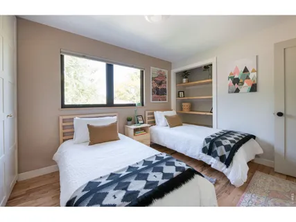 a bedroom with a bed and a window