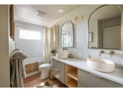 a bathroom with a toilet a sink and mirror