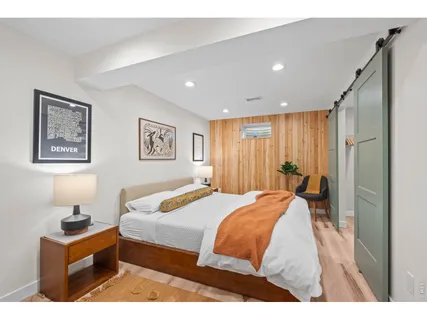 a bedroom with a bed and a large mirror