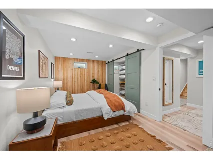 a bedroom with a bed and a large mirror