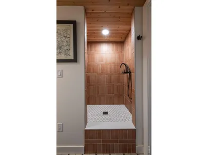 a bathroom with a sink a mirror and shower