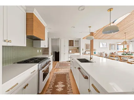 a large kitchen with stainless steel appliances granite countertop a stove and a sink