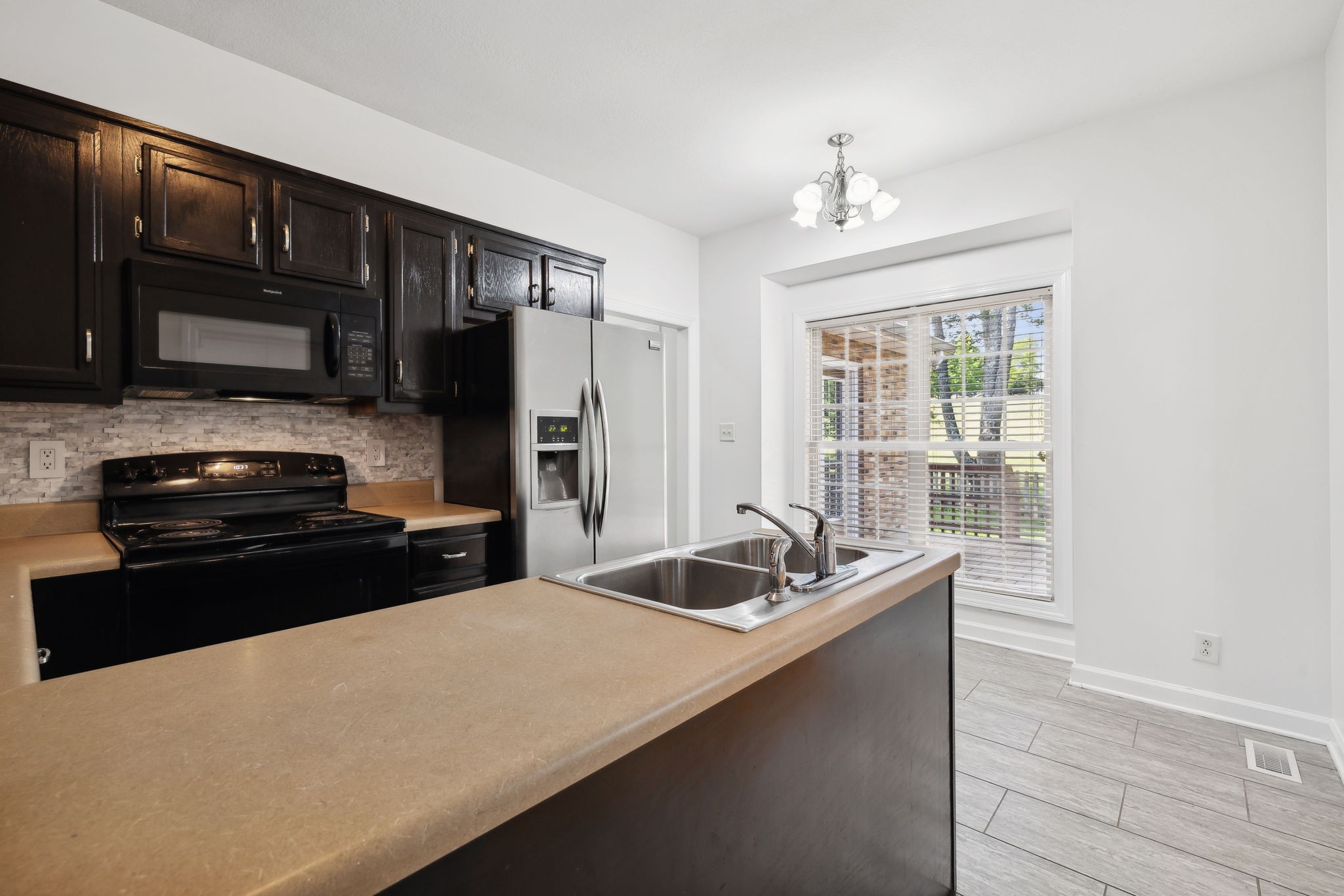3575 Rabbit Run Trail Clarksville, TN 37043 - Photo 13 of 46 a kitchen with granite countertop a refrigerator and a sink