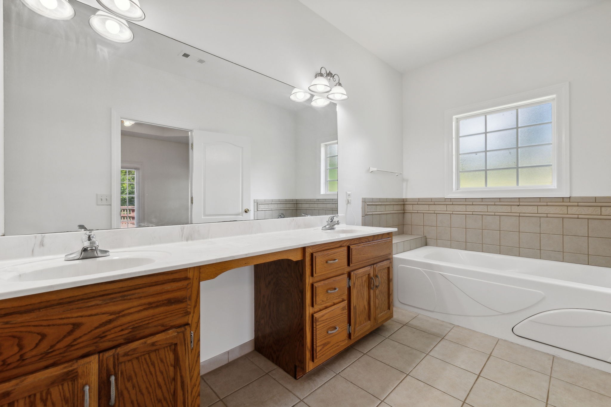 3575 Rabbit Run Trail Clarksville, TN 37043 - Photo 17 of 46 a bathroom with a sink a large mirror and a bathtub