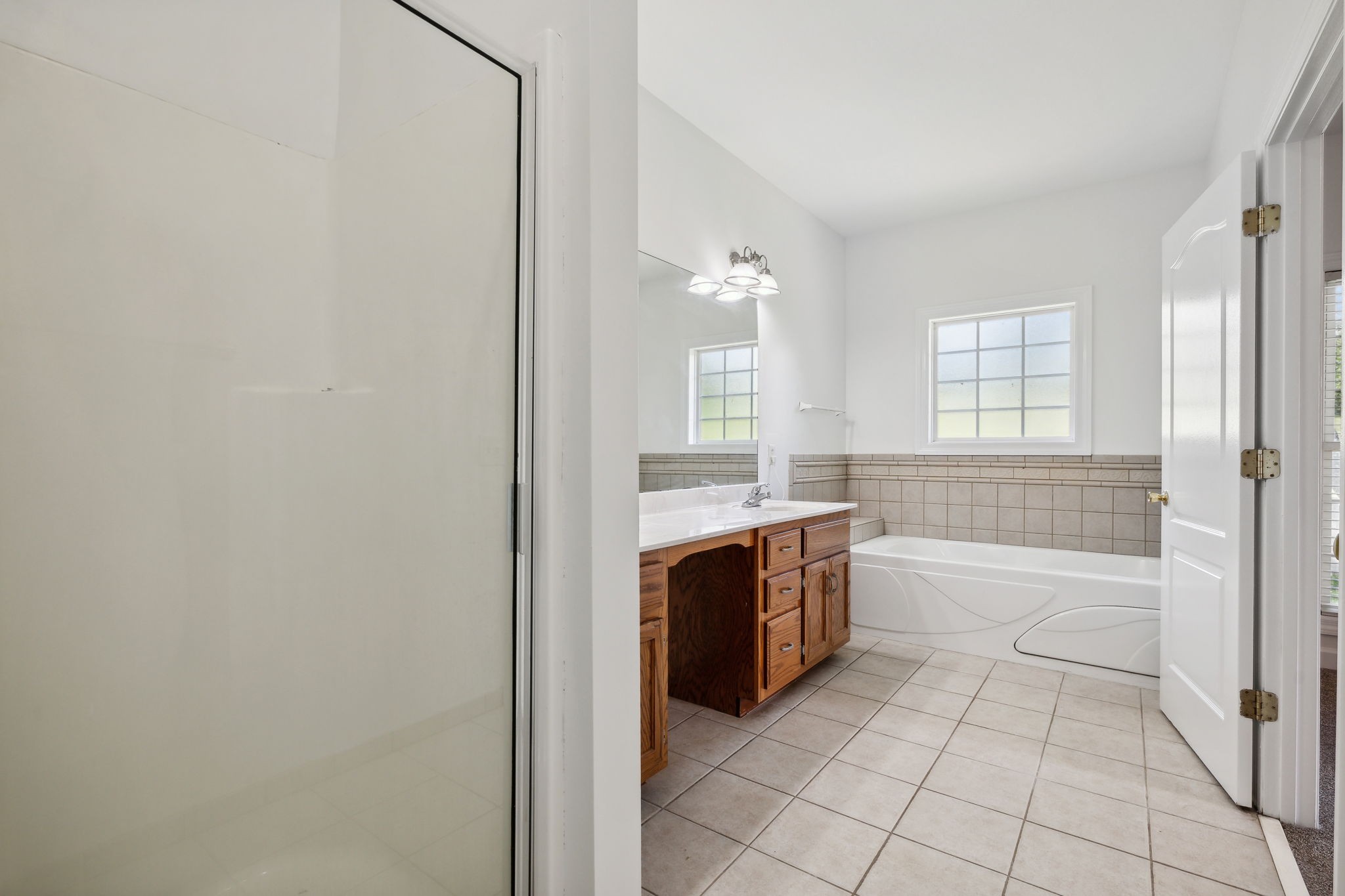 3575 Rabbit Run Trail Clarksville, TN 37043 - Photo 18 of 46 a spacious bathroom with a granite countertop sink a toilet and bathtub