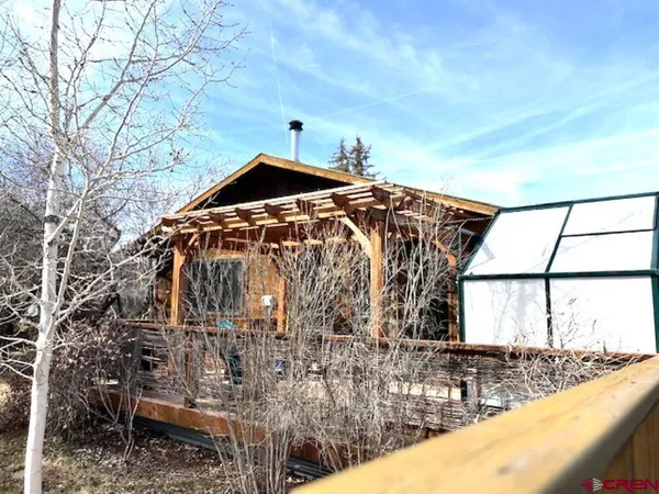 a bedroom with furniture and a flat screen tv