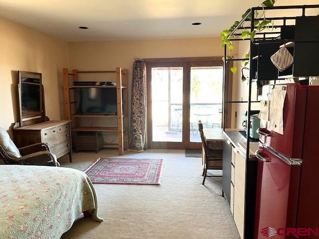 921 North Market Street Cortez, CO 81321 - Photo 26 of 45 a bedroom with furniture and a flat screen tv