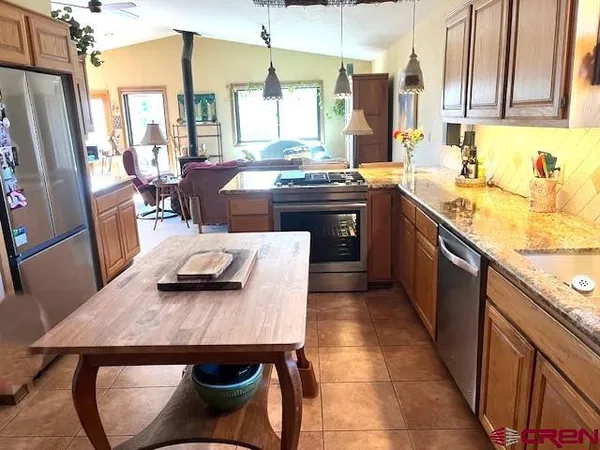 a backyard of a house with yard fountain and outdoor seating