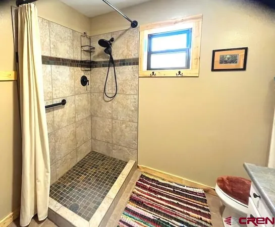 a view of a wooden bench sitting in front of a house