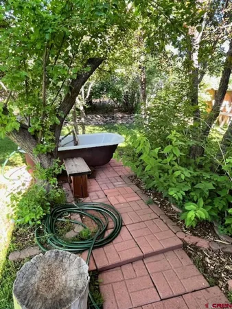 a kitchen with stainless steel appliances granite countertop a refrigerator a microwave a sink and white cabinets