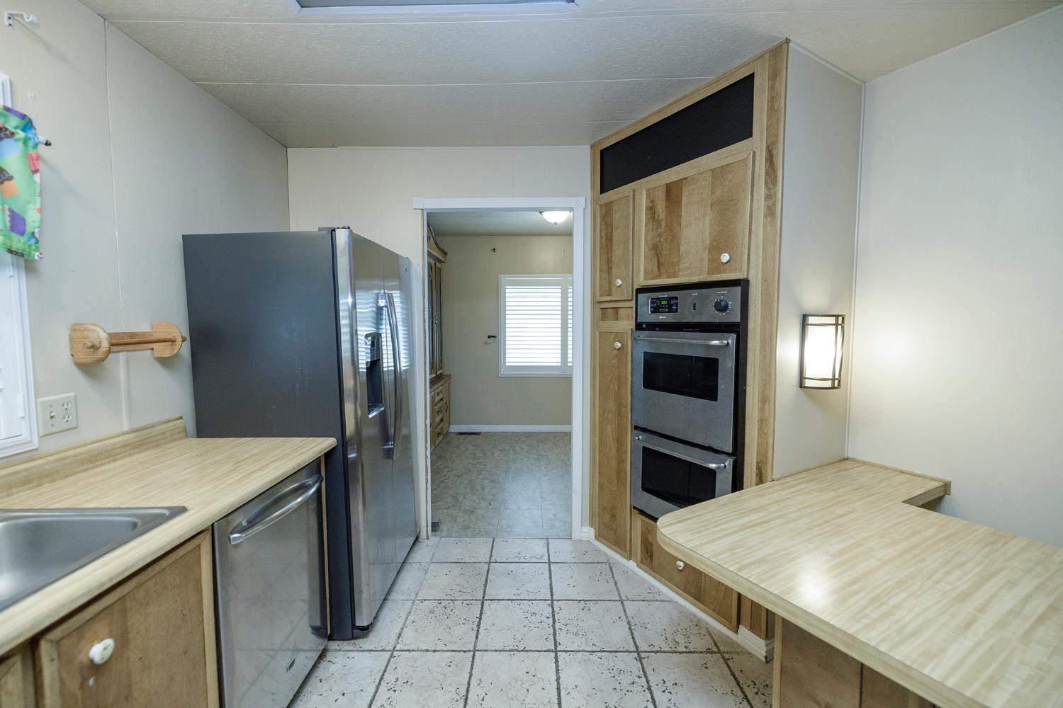 3924 Lahaina Lane Modesto, CA 95355 - Photo 11 of 32 a kitchen with a refrigerator and a sink